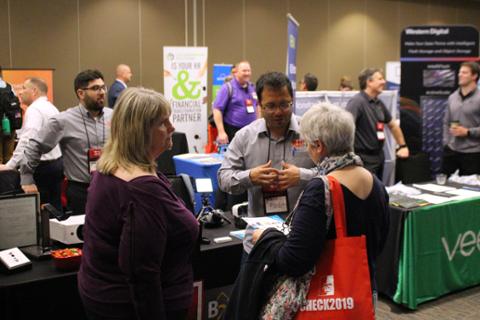CHECK sponsors talking with potential customers about what services they offer.