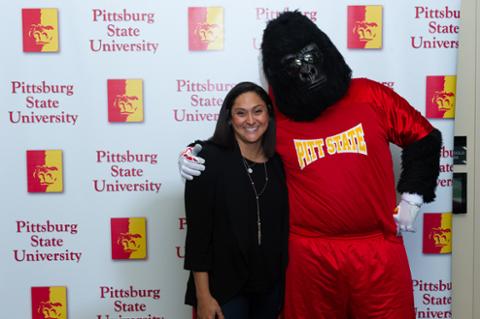 Gus the Gorilla and a female attendee smiling for the camera.