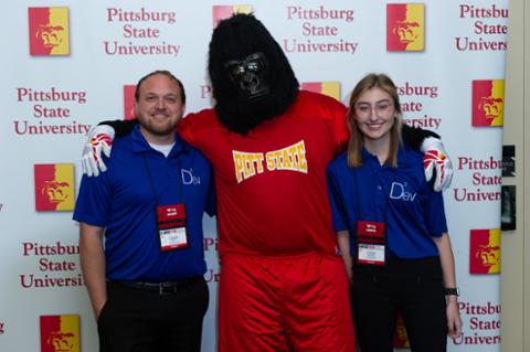 Gus the Gorilla and two team members from DevSquared posing for the camera.
