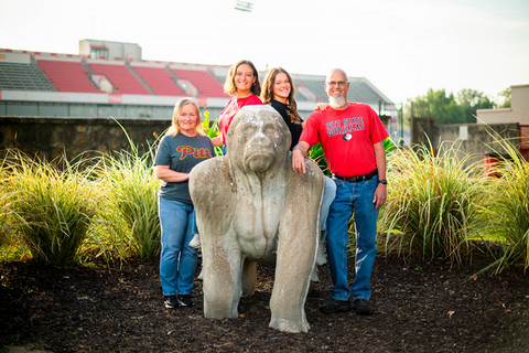 Photo of the Eckstein Family - Emma, Hannah, Heather, and Dan - standing near a gorilla sculpture