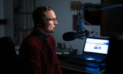 Radio station announcer at controls