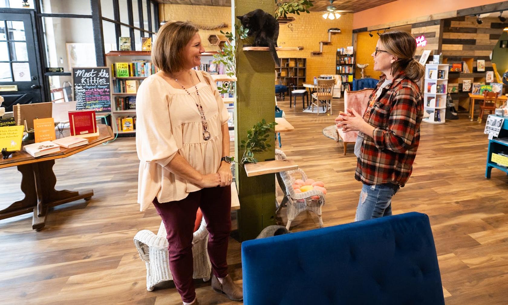 Business counselor visiting with business owner in a bookstore