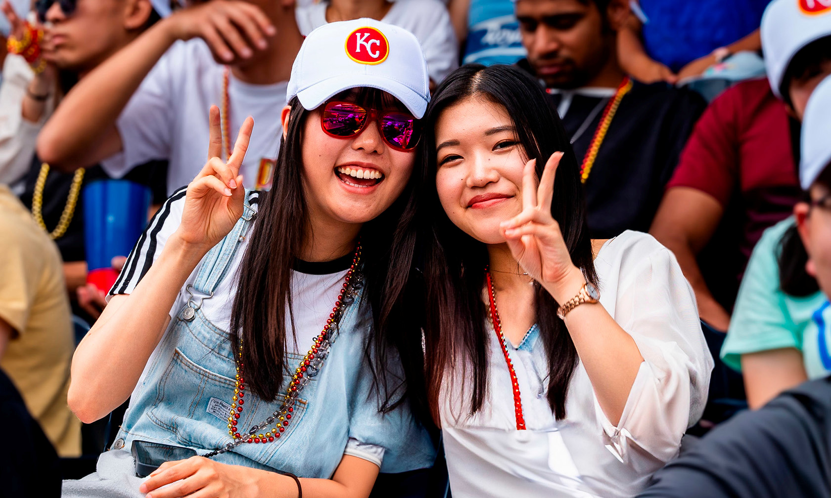 international students in stands at baseball game