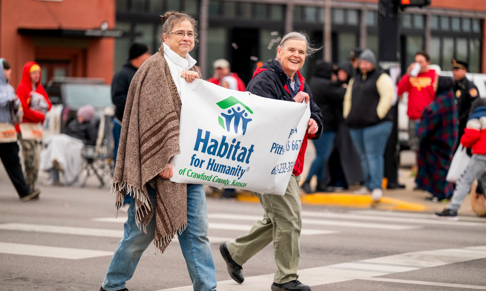 Community members walk in the 2023 Homecoming parade