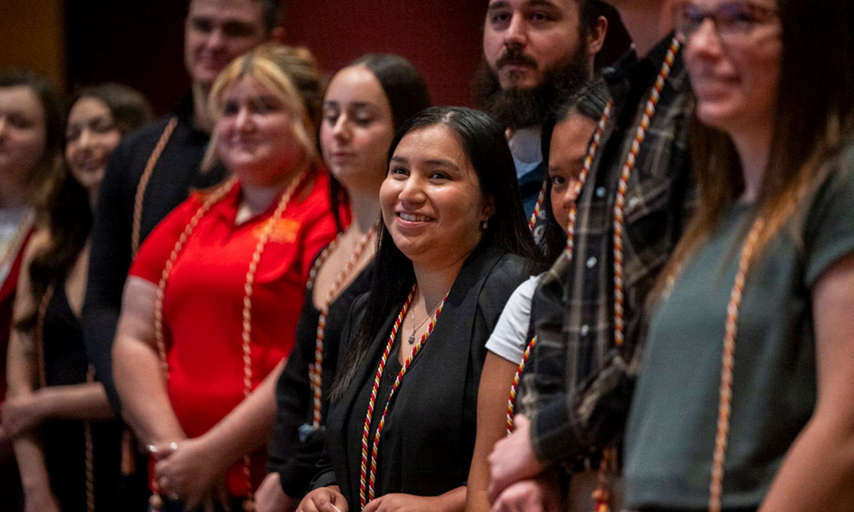 students smiling at AA degree ceremony