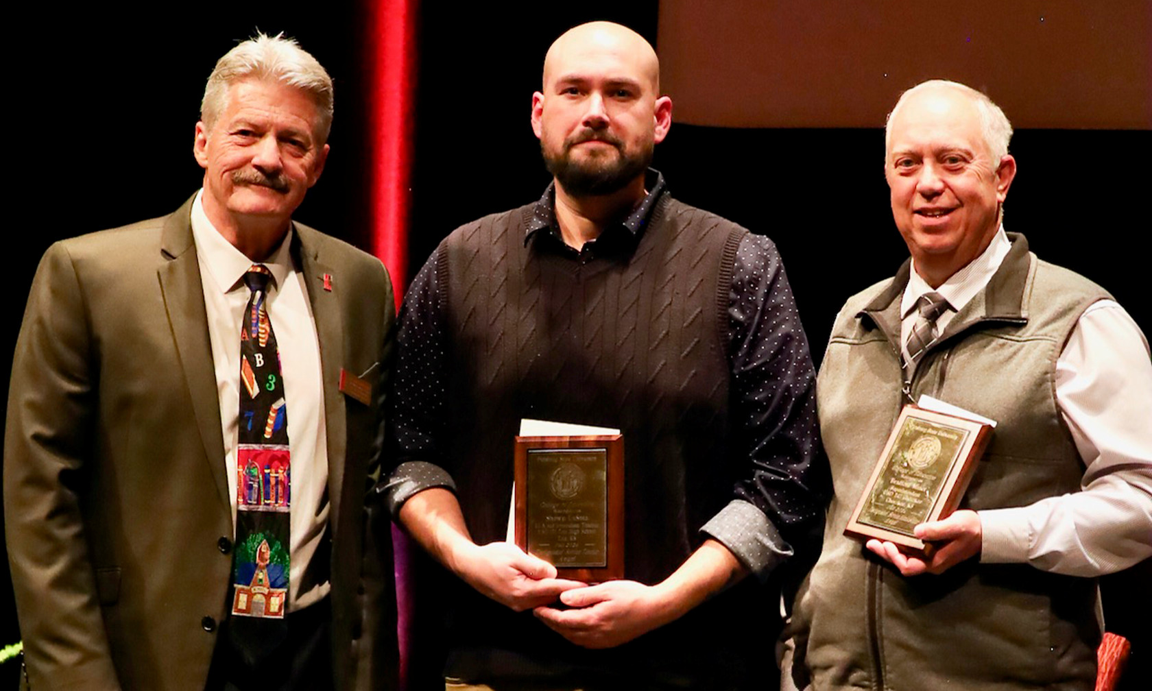 two educators with award