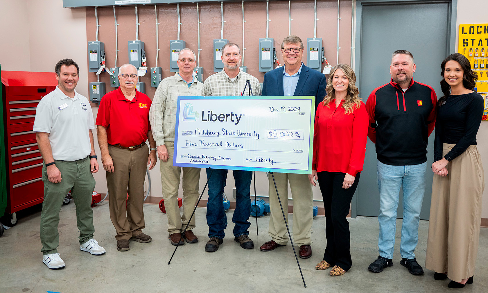 Group of employees with large check