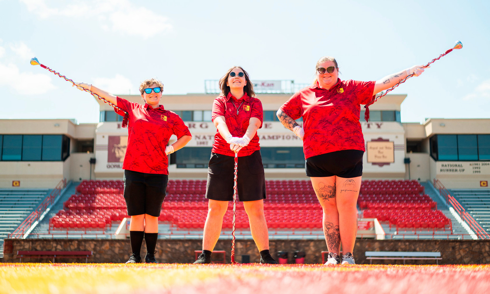 three drum majors on the football field