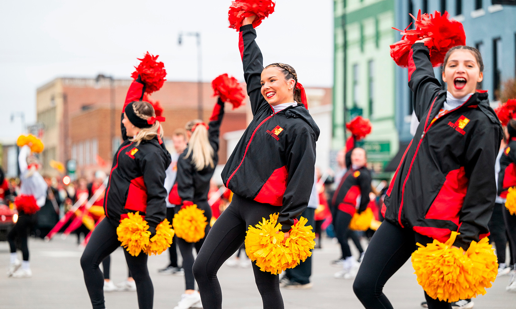 Cheerleaders cheering on Broadway in downtown Pittsburg