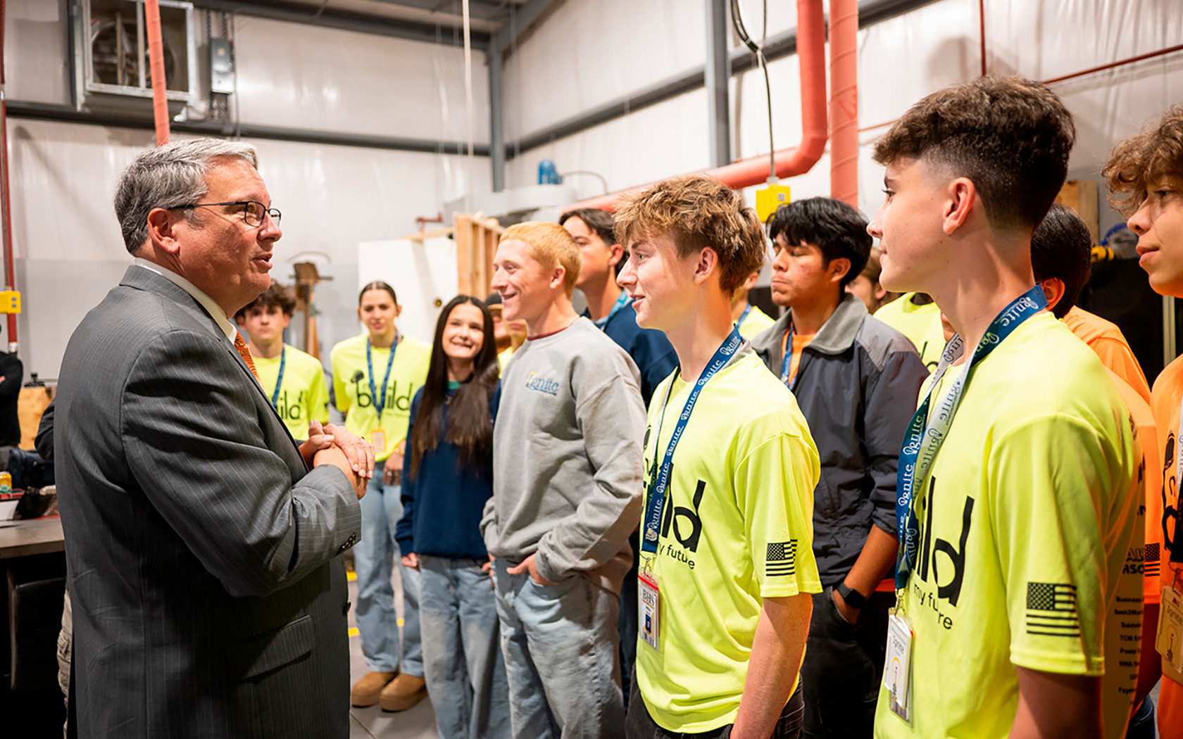 university president meeting with a group of high school students