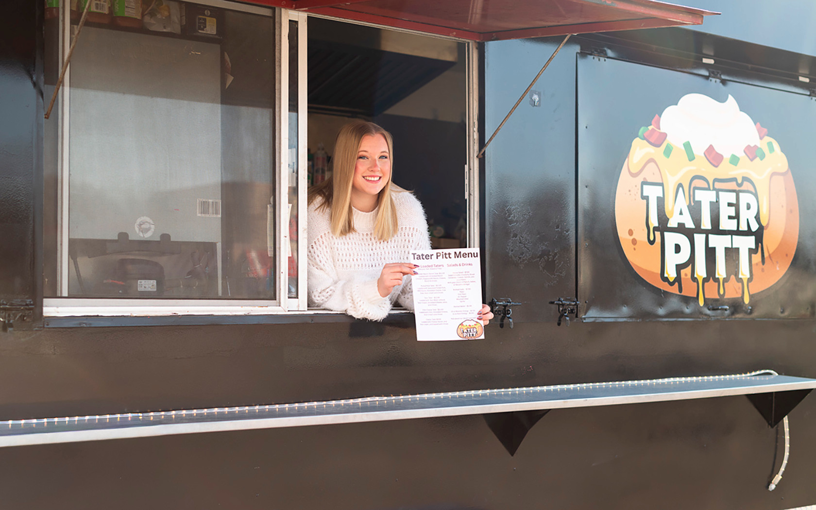 Kelsey in window of her food truck