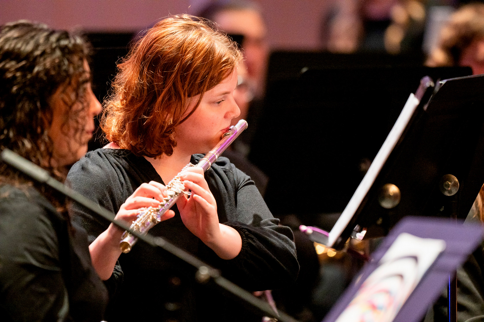 Girl playing flute at wind ensemble concert
