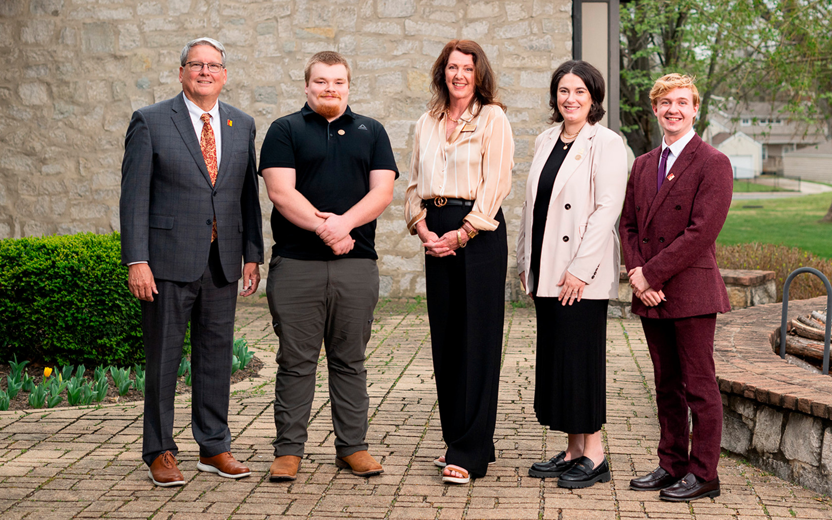 Staff Award Recipients pose with President newsroom an dCharlie outside the presidential home