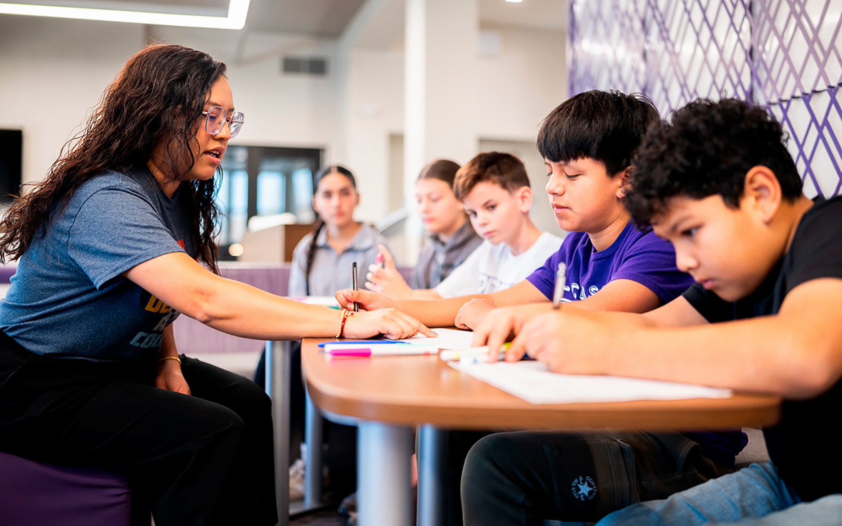 Women works with students at Pittsburg schools