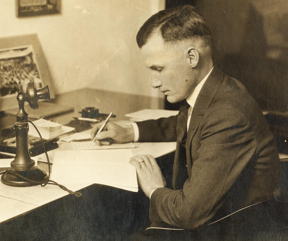 Antique photo of a man writing at a desk