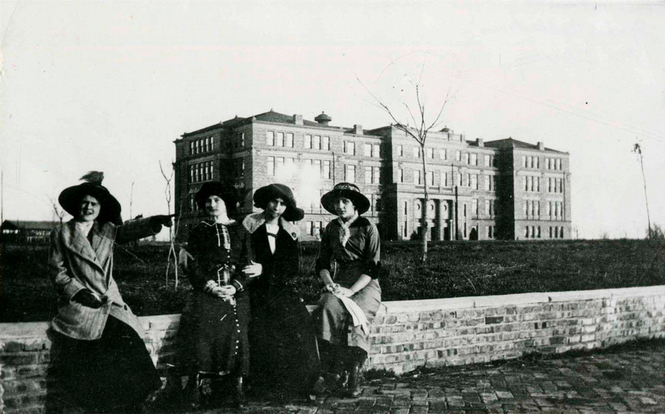 Antique photo of four friends in front of the University